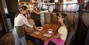 A couple being served by a waitress