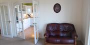 Living room showing doorway to attached kitchen