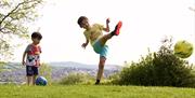 boy kicking a ball at newtownabbey footgolf