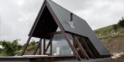 Outside image of lodge with wooden decking and hot tub