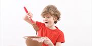 Boy enjoys mixing chocolate at The Chocolate Manor