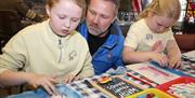 A family enjoying craft activities at the Northern Ireland War Memorial.