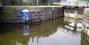 The lock on Toome canal with a sign of opening times.