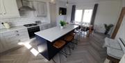 modern open plan kitchen and dining area.