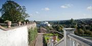 Image is of view of the countryside from high steps in the gardens