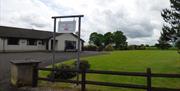 Outside view of house and garden with sign for Rosgarran