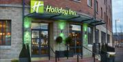 Photo of the entrance of the Holiday Inn Belfast City Centre. Holiday Inn sign above the doors. Stairs and ramp leading to the entrance doors.