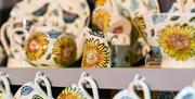 Photo of professionally painted ceramic pieces or sale with a sunflower pattern