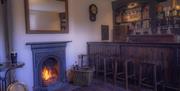 bar area with fireplace and bar stools