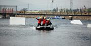 Image shows people in a dinghy on the lake