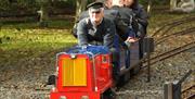 a group of adults on a small train