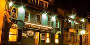 Photo of the exterior front of the building at night time