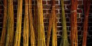 WILLOW DRYING OUT AGAINST A RED BRICK WALL