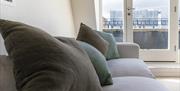 Cushions on a grey sofa.