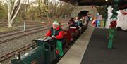 a photograph of a group of people riding the small train