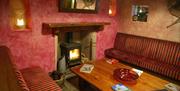 Image of inside restaurant seating area with wood burning stove