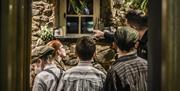 Image of kids being shown the soup kitchen window