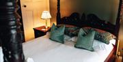 double bed four poster bed in a luxury green room
