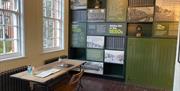 Interior of the Guard Room with information panels on wall and desk with Visitor Book