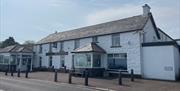 Whitewashed wall exterior of Halfway House Hotel in Ballygally