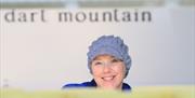 Cheesemaker Julie, making Cheese at Dart Mountain Cheese in Derry. She is filling the cheese molds with curd.