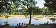 Family ona bench looking over the lake at Hillsborough Forest