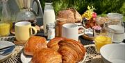 Breakfast served on deck, including freshly baked croissants and pain au chocolat
