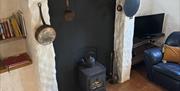 Living room with wood burning stove and traditional artefacts