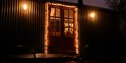 Night view of the hut toward the French doors, illuminated at Christmas time
