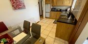 Kitchen with black counter tops and tiled backsplash