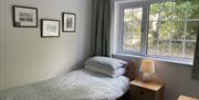 Reception room showing open tread stairs to the attic bedroom, sofa and armchairs.