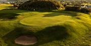 Silhouettes of golfers on the green