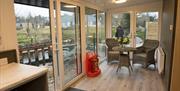 kitchen and dining area with bunch of flowers on table