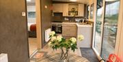 kitchen and dining area with bunch of flowers on table