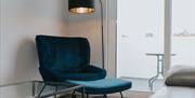 Lounge chair and lamp beside patio window