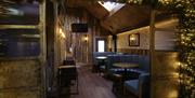 rustic seated area inside The Lower House Bar