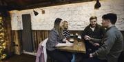 Group of friends seated at a table having drinks