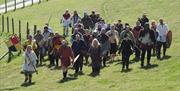 Large group of Magnus Vikings climbing a hill with shields and swords