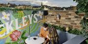 Couple sitting on outside decking at McAleers Bar