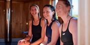 Group smiling inside the sauna.