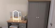 Grey dresser and wardrobe