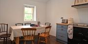 A kitchen/dining room with a table for six.
