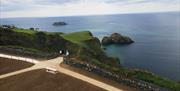 people standing on the viewing platform at Portaneevy View Point. Sheep Island and Carrick a rede island can be seen in the background