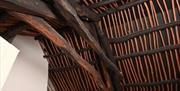 A restored old wooden beam ceiling.
