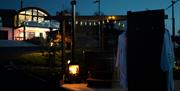 Outdoor Night shot of Lodge and spa facilities with fire ambiance