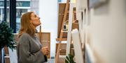 A girl perusing the art in artist Frankie Creith's studio and workshop