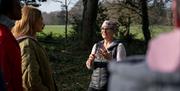 Group listening to instructor Jane outside as part of the Journey into Stillness experience