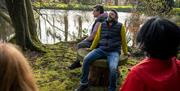 Group relaxing outside with their eyes closed enjoying the Journey into Stillness experience