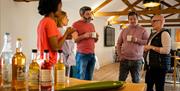 Group standing inside enjoying refreshments with instructor Jane as part of the Journey into Stillness experience