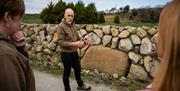 Instructor Mark showcasing a dry stone wall to the group as part of the Mourne Dry Stone Wall Building experience